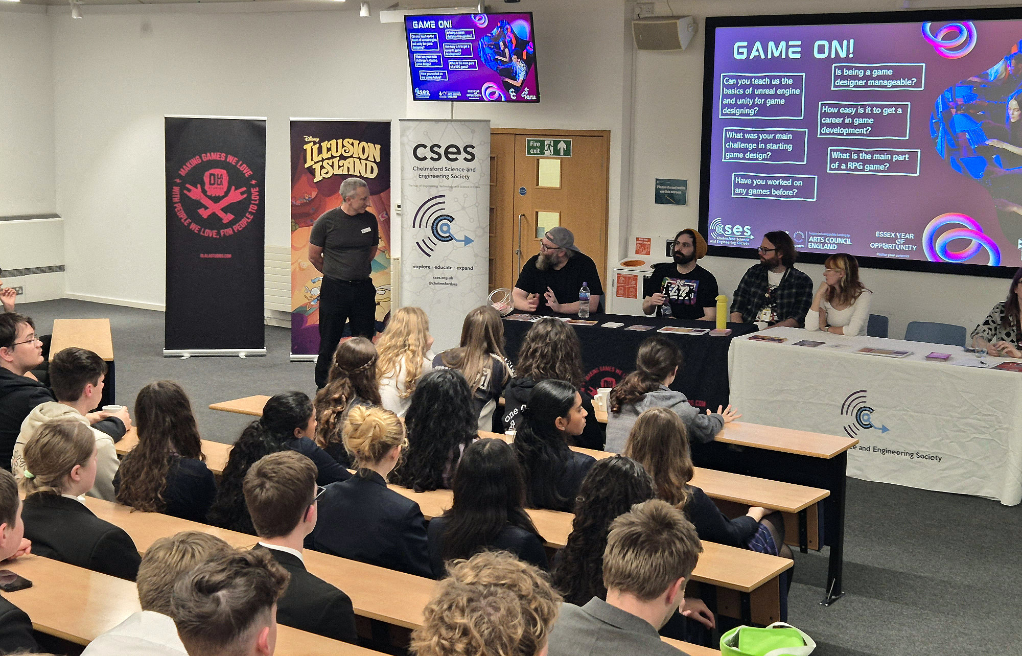 A Q&A panel at the Game On conference with games designers on the panel and school students in the audience